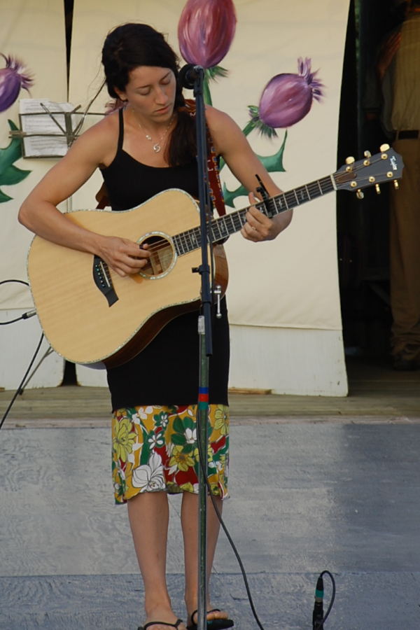 [dsc_6051.jpg] Erin Martell singing self-accompanied on guitar