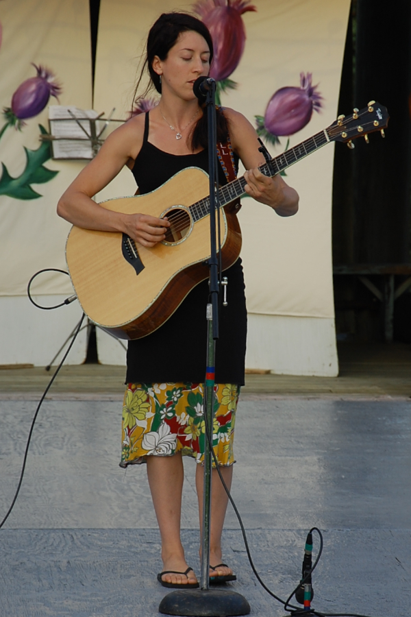 [dsc_6052.jpg] Erin Martell singing self-accompanied on guitar