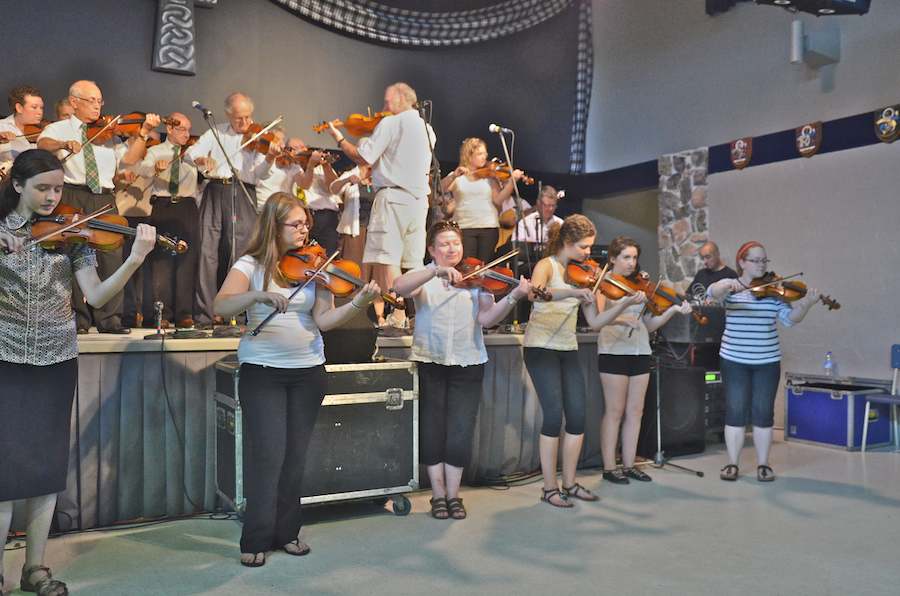 Cape Breton Fiddlers’ Association Third Group Number, directed by Eddie Rogers and accompanied by Lawrence Cameron on keyboards and James Boudreau on guitar