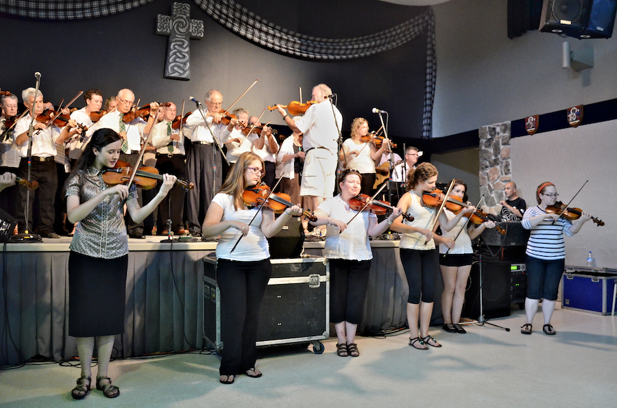 Cape Breton Fiddlers’ Association Third Group Number, directed by Eddie Rogers and accompanied by Lawrence Cameron on keyboards and James Boudreau on guitar