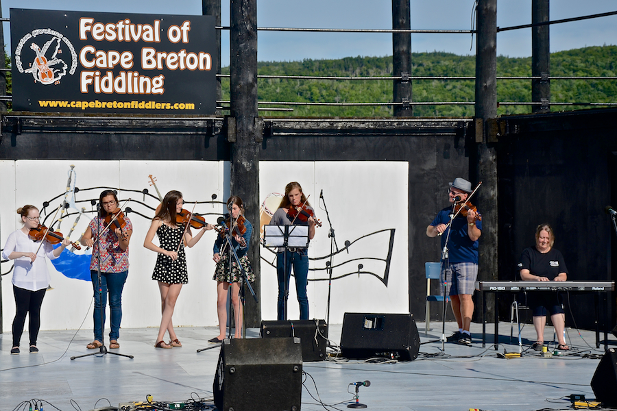 Kyle MacNeil with five of his students on fiddle accompanied by Susan MacLean on keyboard