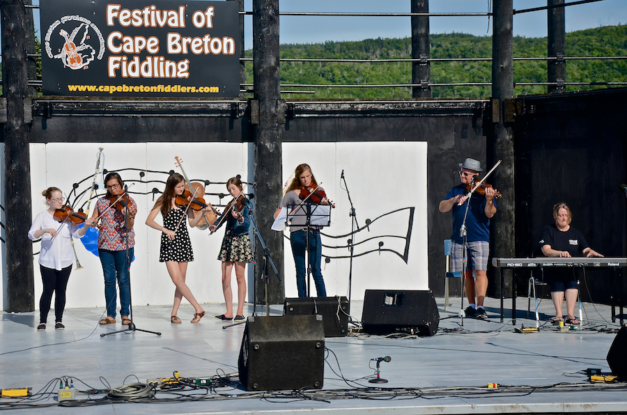 Kyle MacNeil with five of his students on fiddle accompanied by Susan MacLean on keyboard