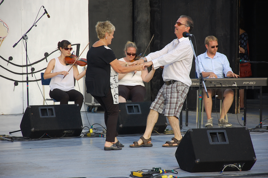 Betty Matheson and Larry Parks do a celebratory step dance to the music of Stephanie MacDonald and Dara Smith-MacDonald on dual fiddles accompanied by Adam Young on keyboard