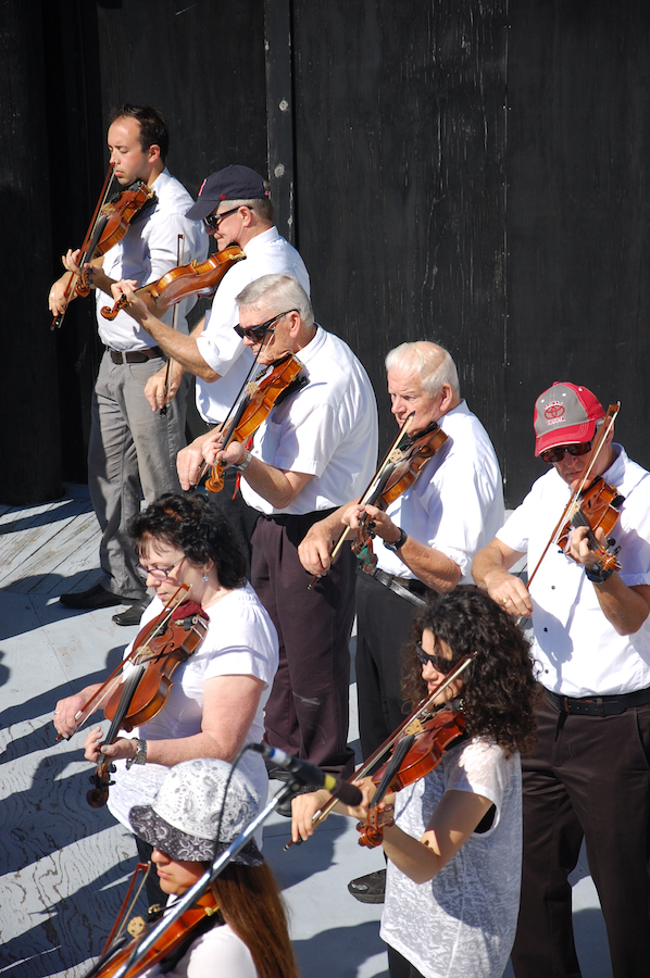 The Cape Breton Fiddlers’ Association plays its second group number in tribute