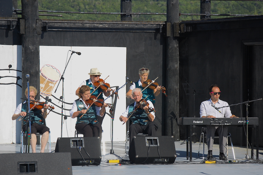 A contingent of the PEI Queens County Fiddlers accompanied by Kolten MacDonell on keyboard