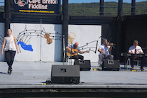Stephanie MacDonald step‑dancing to the music of Rodney MacDonald on fiddle, Lawrence Cameron on keyboard, and Mike Barron on guitar