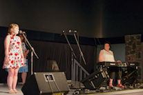 Julia Rideout sings O Canada!, accompanied by Marilyn Clary Morrison on keyboard