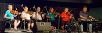 A contingent of the PEI Fiddlers accompanied by Howie MacDonald on keyboard