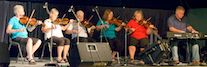 A contingent of the PEI Fiddlers accompanied by Howie MacDonald on keyboard