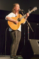 Mary Beth Carty singing and accompanying herself on guitar