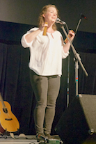 Mary Beth Carty singing and accompanying herself on “bones”