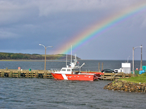 Rainbow over a Coast Guard cutter in Chéticamp