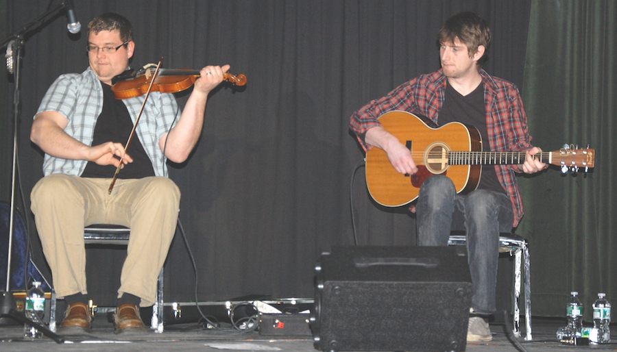 Photo of J. J. Chaisson on fiddle accompanied by Koady Chaisson on guitar
