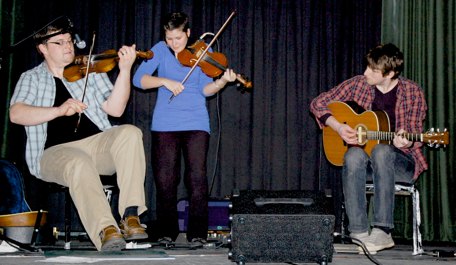 Photo of J. J. Chaisson and Zoë Darrow on fiddles accompanied by Koady Chaisson on guitar
