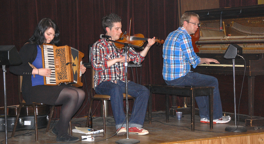 Photo of Colin Grant on fiddle accompanied by Adam Young on piano and Fiona Black on accordion