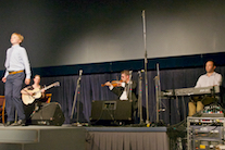 Iain MacQuarrie step dancing to the music of Ashley MacIsaac on fiddle, Kolten Macdonell on keyboard, and Mary Beth Carty on guitar