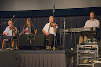 Donald MacPhee, Koryne Fraser, and Bernard McDonell on triple fiddles accompanied by Kolten Macdonell on keyboard