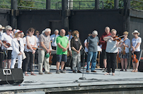 Dara Smith-MacDonald on fiddle and Kolten Macdonell on keyboard (hidden) play a lament for the fallen members as the association members, founding members, and directors look on