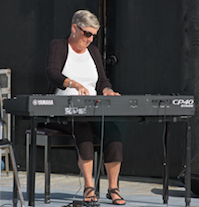 Carol Ann MacDougall playing a solo on keyboard