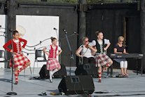 Emma MacNeil, Amelie Bates, and Mia Nordine dancing a Highland Fling to the music of Dara Smith-MacDonald on fiddle and Betty Lou Beaton on keyboard