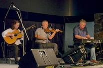 Rodney MacDonald on fiddle, Howie MacDonald on keyboard, and Mary Beth Carty on guitar